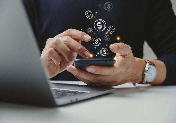 24-51 Hand of businessman using smart phone with coin icon, Online transaction, fintech business, Internet investment e-Commerce concept.